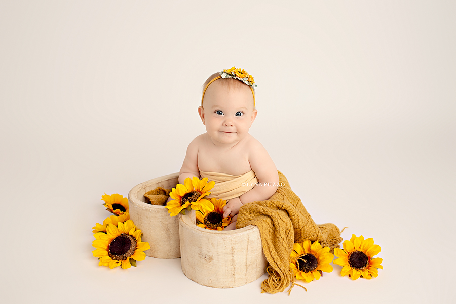 sitter milestone session with baby girl and sunflowers