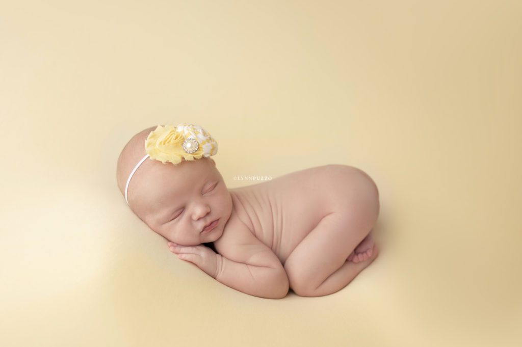 newborn girl on yellow
