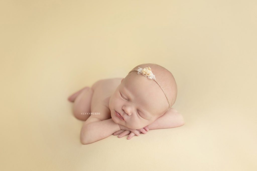 newborn baby girl on yellow
