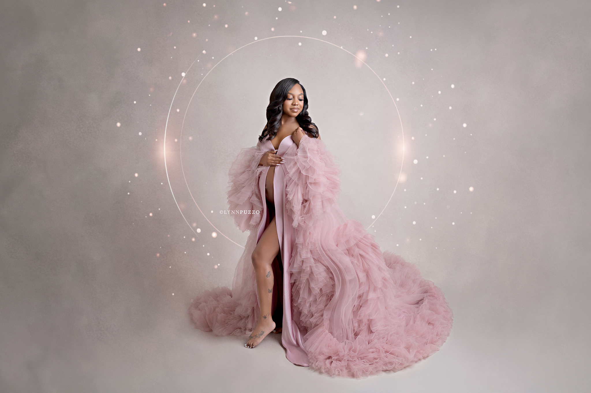 celebrating motherhood through maternity portraits in soft pink gown Atlanta studio