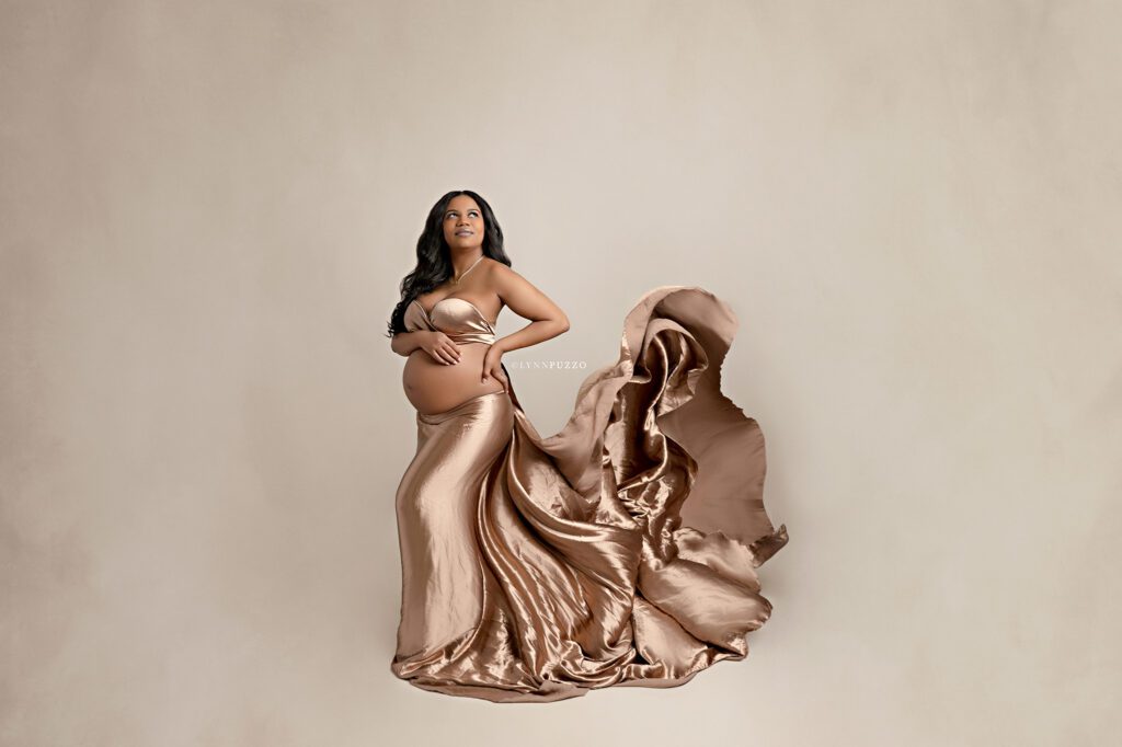 Luxury studio maternity photography with metallic brown fabric