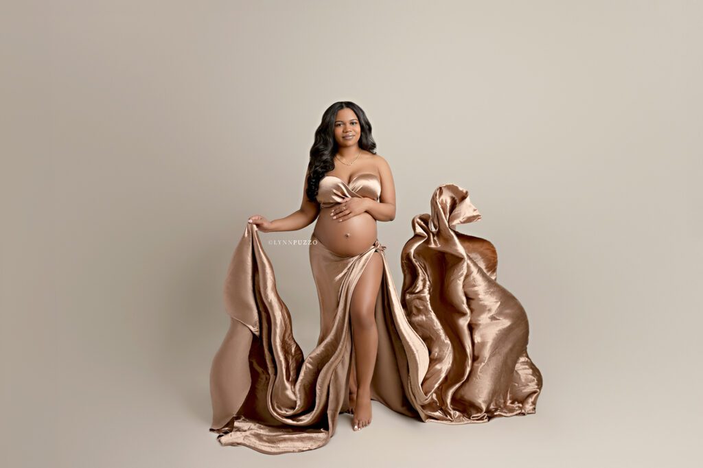 Luxury studio maternity photography with metallic brown fabric